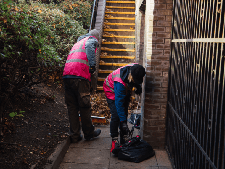 Image of two people llitter picking in the community